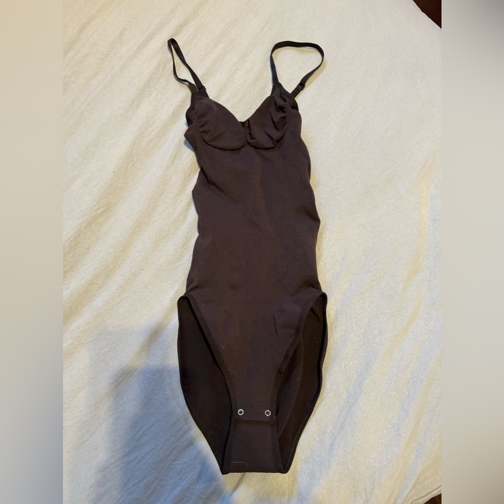 Black contouring body suit